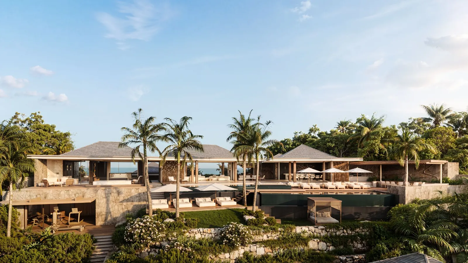 A villa above the sea, terraces and pools among palms